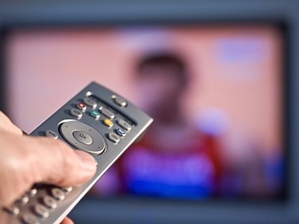 TV remote in front of blurred television